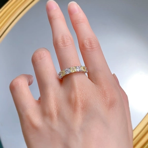 Close-up of S925 silver ring featuring alternating yellow and white emerald-cut stones