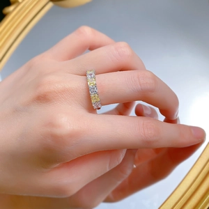 Macro shot of S925 silver eternity ring with yellow and white square-cut diamonds