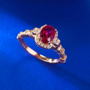 Elegant S925 silver ring with oval ruby-red stone and rose gold finish in macro view