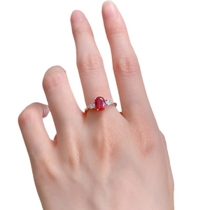 Classic S925 silver ring with oval ruby and pear-shaped side stones on a model's hand