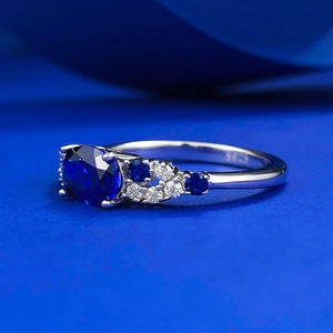 Detailed macro view of S925 silver ring featuring an oval deep blue sapphire gemstone