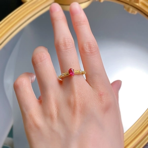 Close-up of S925 gilded ring with oval pigeon blood red ruby and vintage relief details