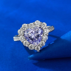 Macro view of heart-cut lavender carbon diamond ring with silver halo and pavé band