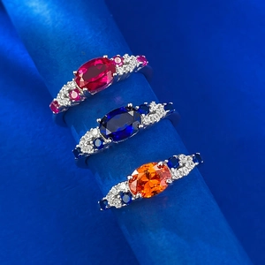 Detailed close-up of three S925 silver rings with oval red, blue, and orange gemstones
