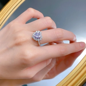 On-hand view of a 925 silver heart ring with lavender purple stone and halo diamonds