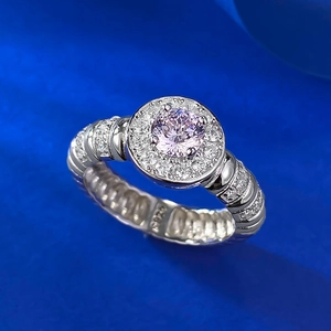 Macro detail of S925 silver ring featuring round pink center stone and textured band