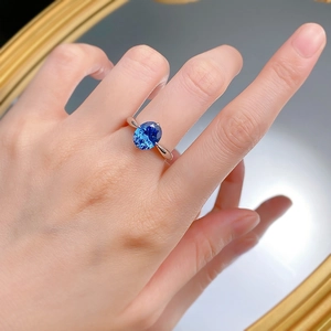Detailed close-up of a hand wearing a S925 silver ring with a large oval royal blue gemstone