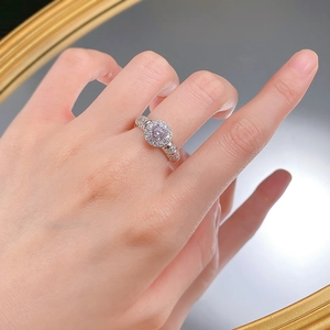 Macro view of S925 silver ring featuring micro-pave diamonds and a pink center stone