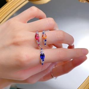 Detailed close-up of three S925 silver rings with blue, ruby red, and orange oval gemstones