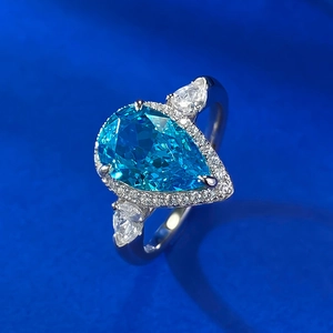 Macro shot of 7x11 pear cut blue gem ring with halo diamonds on S925 silver band