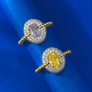 Macro detail of gold plated S925 silver rings with purple and yellow oval gemstones