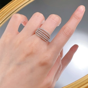 Close-up of a wide multi-row silver ring featuring five bands of shimmering paved crystals