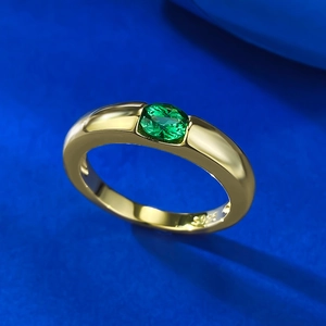 Elegant S925 gilded silver ring with oval green gemstone on a textured blue fabric