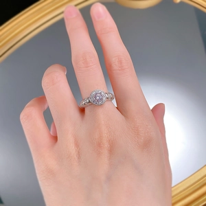 Close-up of S925 silver halo ring with pink round stone on model's hand and mirror background