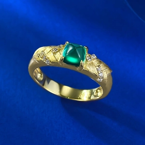 Macro shot of 18K gold plated S925 silver ring with emerald zircon and brushed metal finish