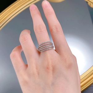 Detailed view of luxury five-row pave diamond ring in silver on a model's hand
