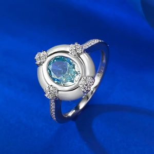 Macro detail of S925 silver ring featuring an oval blue gemstone and micro-pave diamonds