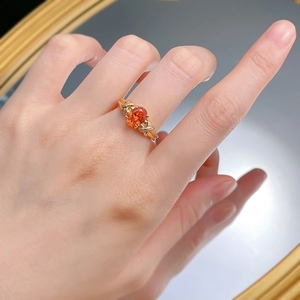 Close-up of S925 silver ring with oval orange gemstone and intricate textured band