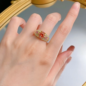 Close-up of S925 silver vintage orange gemstone ring with sparkling pink accent diamonds