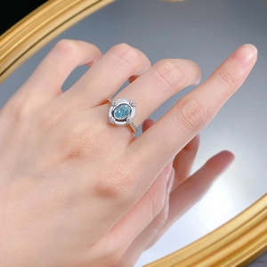 Close-up of S925 silver ring featuring an oval aquamarine stone and enamel detail