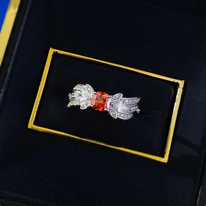 S925 silver ring with 1ct orange gemstone and angel wing side stones in a jewelry box