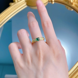 Detail of S925 silver gold plated ring with emerald-cut zircon and brushed finish texture