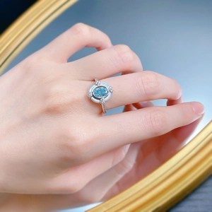 Detail of S925 silver ring featuring an oval blue stone with white enamel and pavé diamonds
