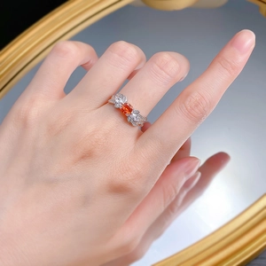 Close-up of S925 silver ring with 1-carat orange gemstone and butterfly wing detail