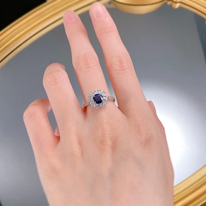 Close-up of S925 silver ring featuring 6mm blue corundum with halo diamond setting
