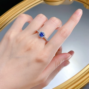 Détail d'une bague en argent S925 avec une pierre carrée bleu royal et entourage diamants