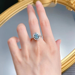 Close-up of S925 silver ring featuring an oval blue stone and shimmering accent diamonds