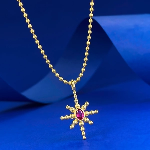 S925 silver gold-plated sunburst necklace pendant with red oval gemstone on blue background