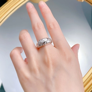 Detail of wide S925 sterling silver ring featuring mixed cut sparkling zircon stones