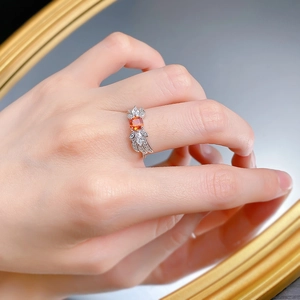 Detailed close-up of S925 silver ring featuring square orange stone and feather side accents