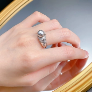 Detailed close-up of a luxury 8mm grey pearl ring with shimmering zircon micro-paving