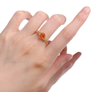 S925 sterling silver ring with oval orange gemstone on elegant golden crisscross band