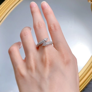 Macro detail of silver snake ring with pavé diamonds and pear-cut stones