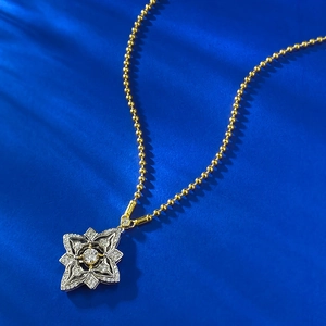 Silver four-leaf clover pendant necklace with diamonds on a gold beaded chain