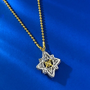 Detailed shot of S925 silver clover necklace with geometric cutout and gold accents