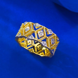 Lace hollow geometric gold-plated silver ring with sparkling round stones on blue background