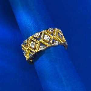 Macro detail of geometric lace hollow ring with dual-tone silver and gold pavé diamonds
