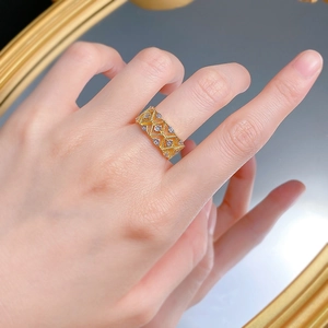 Macro shot of gold-plated geometric lace ring with sparkling cubic zirconia detailing