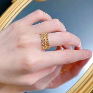 Detail of a vintage 925 silver gold-plated lace hollow ring with pavé sparkling diamonds