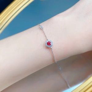 Macro view of S925 silver bracelet featuring a flower-shaped pigeon blood red gemstone