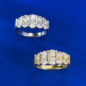Macro shot of silver and gold double-row pavé rings with round cubic zirconia stones