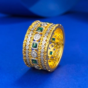 Luxurious gold plated S925 silver ring featuring emerald cut green stones and pavé diamonds