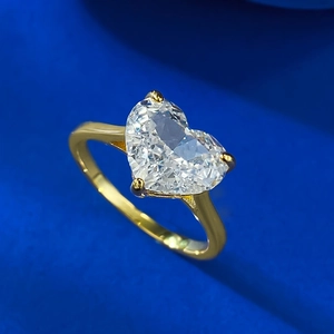 Classic gold ring with a large 10x8mm heart-shaped carbon diamond on blue velvet