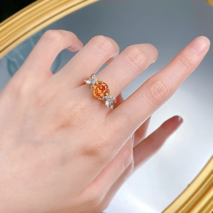 Close-up of S925 silver ring with 7x9mm oval sunset orange stone and marquise accents