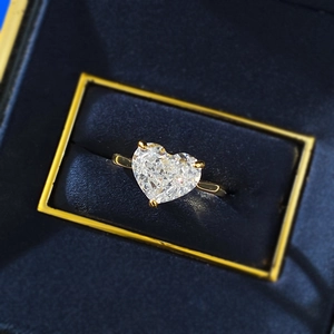 Close-up of 10x8mm heart-cut high carbon diamond ring on elegant blue velvet box