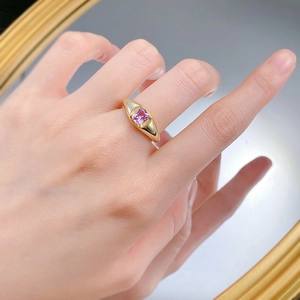 Close-up of S925 silver ring with 5x6mm pink sapphire on hand over mirror